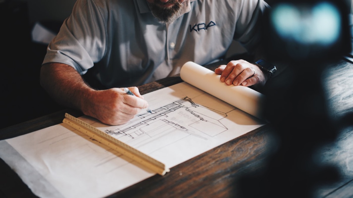 Hand-drafted architectural elevation in progress on a drafting table