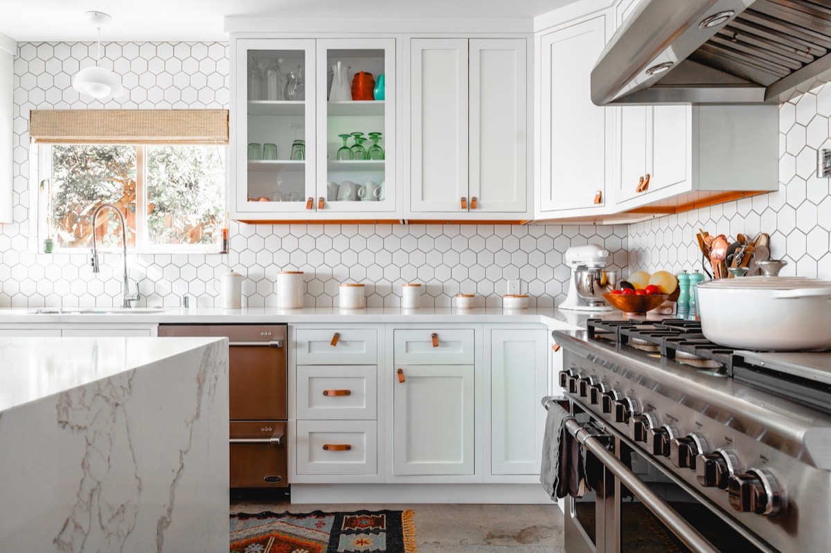 Remodeled kitchen with custom cabinetry, stone island and designer millwork